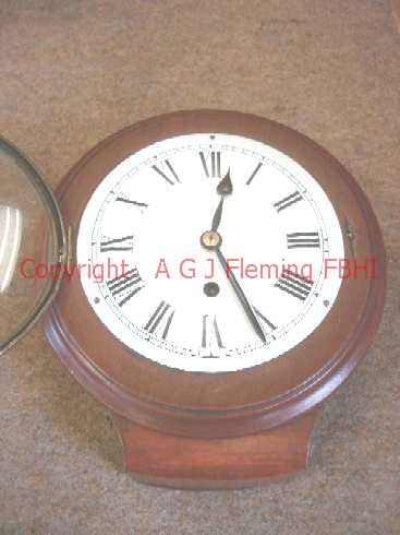 Front view of German drop dial clock, glazed bezel open